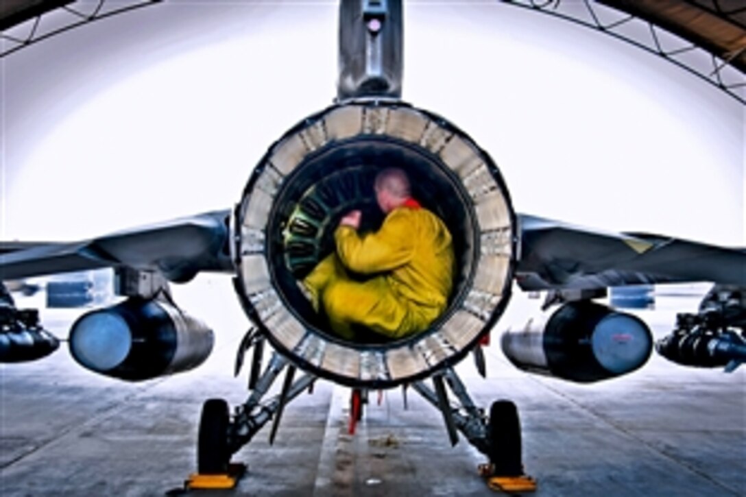 U.S. Air Force Senior Airman Nate Hall conducts a post-flight inspection on an F-16 Fighting Falcon aircraft on Kandahar Airfield, Afghanistan, July 5, 2013. Hall, an aircraft maintainer assigned to the 451st Expeditionary Aircraft Maintenance Squadron, inspects aircraft for leaks, cracks or anything that may jeopardize the integrity of the aircraft.