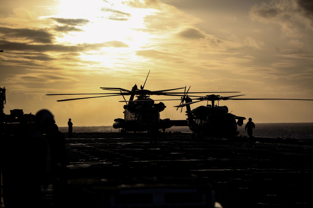 A CH-53E Super Stallion helicopter from Marine Medium Tiltrotor Squadron 265 (Reinforced), 31st Marine Expeditionary Unit, and a SH-60 Seahawk helicopter of Helicopter Sea Combat Squadron 25, await clearance to take off here, July 17. The 31st MEU and Amphibious Squadron 11 are part of the 18,000 U.S. personnel participating in the month long, bilateral training exercise alongside more than 9,000 Australian soldiers in the fifth iteration of Talisman Saber.