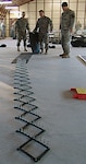 Members of the 56th Stryker Brigade Combat Team, 28th Infantry Division, practice laying out spike strips during non-lethal capability set training at Fort Dix, N.J.