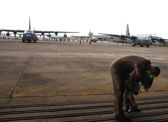 A Marine Aerial Refueler Transport Squadron 252 Marine bids farewell to his child Wednesday before departing for Afghanistan. The Marines, along with  detachments from a variety of fields, are filling critical roles as  2nd Marine Aircraft Wing (Forward) nears the halfway mark of its one-year deployment.