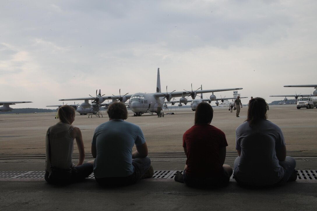 Family members of a Marine Aerial Refueler Transport Squadron 252 Marine sit on the flightline Wednesday before their loved one departs for Afghanistan. The Marines, along with  detachments from a variety of fields, are filling critical roles as  2nd Marine Aircraft Wing (Forward) nears the halfway mark of its one-year deployment.