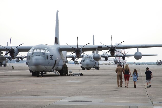 A Marine Aerial Refueler Transport Squadron 252 Marine and his family walk to a KC-130J Wednesday before departing for Afghanistan. The Marines, along with  detachments from a variety of fields, are filling critical roles as  2nd Marine Aircraft Wing (Forward) nears the halfway mark of its one-year deployment.