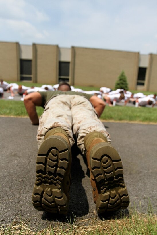 MORRISVILLE, N.Y. - Sergeant Adam T. Leyendecker, the marketing and public affairs representative at Recruiting Station Buffalo, leads his group of boys in a set of push-ups during the annual New York American Legion Boy's State at the State University of New York, Morrisville, June 24.  Boy's State is a week-long civics and government camp for incoming high school seniors sponsored by the American Legion designed to give participants a better understanding of American governance.