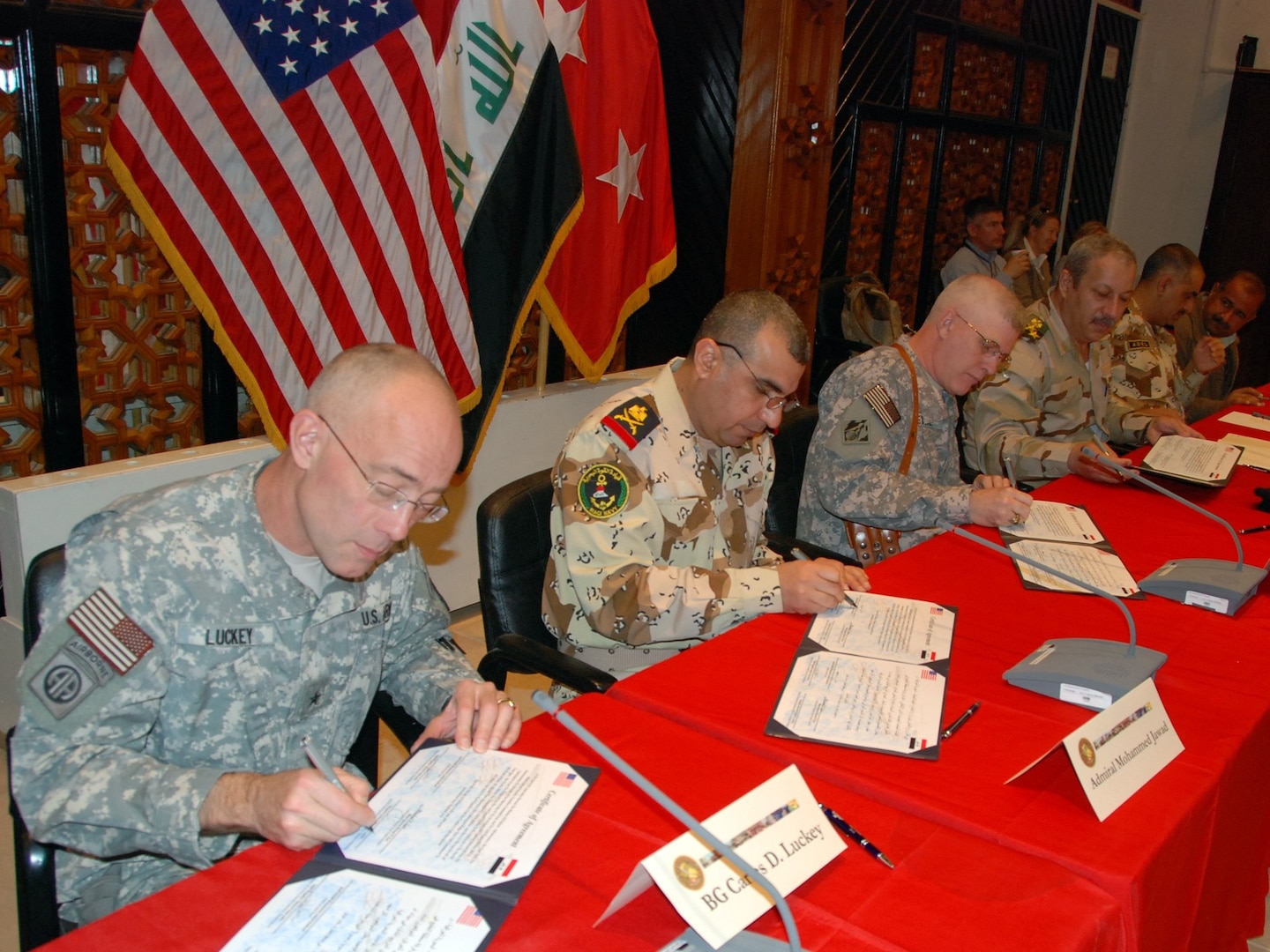 U.S. and Iraqi officials sign a certificate of agreement at the Gulf Region Division headquarters in Baghdad, Feb. 12, 2009, signaling design approval for the $53 million Umm Qasr pier and seawall project.