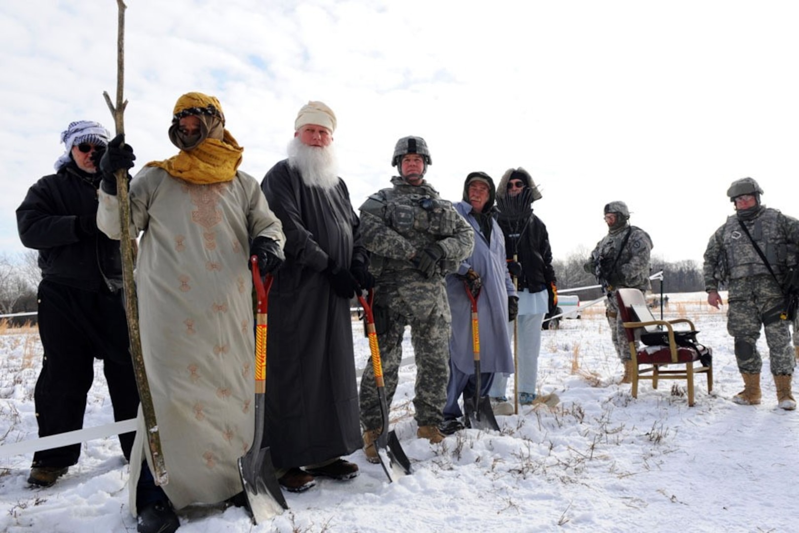 Army Col. Brian Copes, fourth from left, 1-19th Agribusiness Development Team commander, participates in a mock groundbreaking ceremony on a snowy day at the Muscatatuck Urban Training Center, a sub-installation of Camp Atterbury, Ind. The ceremony is part of the team's preparation to deploy to Afghanistan's Khowst province, Afghanistan.