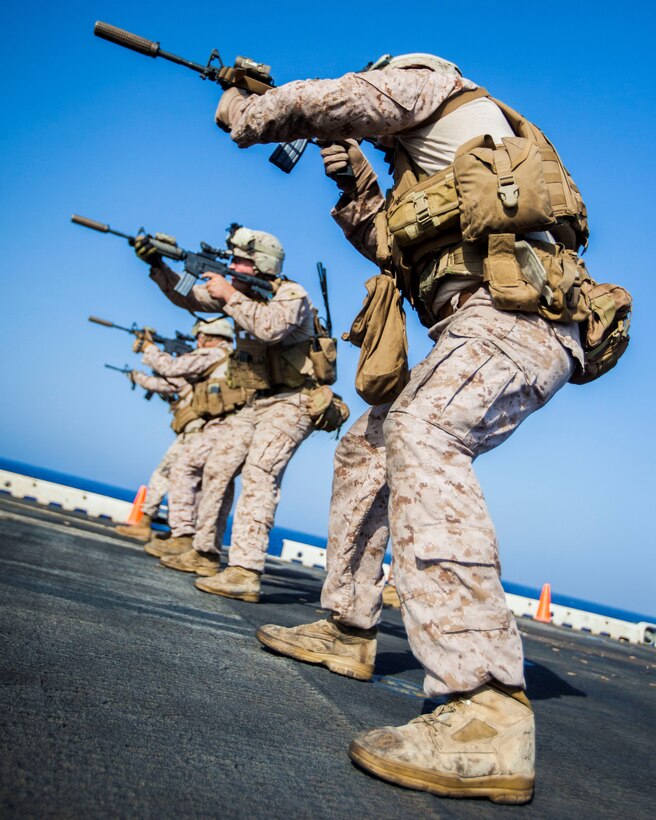 U.S. Marines assigned to Scout Sniper Platoon, Battalion Landing Team 3/2, 26th Marine Expeditionary Unit (MEU), conduct an M4 Carbine live-fire exercise on the flight deck of the USS Kearsarge, at sea, July 18, 2013. The 26th MEU is a Marine Air-Ground Task Force forward-deployed to the U.S. 5th Fleet area of responsibility aboard the Kearsarge Amphibious Ready Group serving as a sea-based, expeditionary crisis response force capable of conducting amphibious operations across the full range of military operations. (U.S. Marine Corps photo by Sgt. Christopher Q. Stone, 26th MEU Combat Camera/Released)