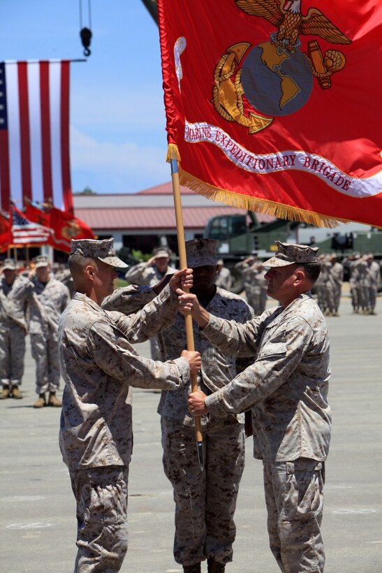 Brig. Gen. Carl E. Mundy III receives the colors from Maj. Gen. John J. Broadmeadow during a change of command ceremony at Camp Pendleton, July 17. During the ceremony Brig. Gen. Carl E. Mundy III relieved Maj. Gen. John J. Broadmeadow as the commanding general of 1st Marine Expeditionary Brigade.