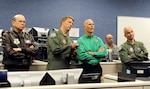 Col. Randy Spear (second from left), 601st Air and Space Operations Center commander, points out a simulated "track of interest" on a radar screen during an exercise to Florida Gov. Rick Scott at Tyndall Air Force Base, Fla., Jan. 5. Scott came to Tyndall to visit with Florida Air National Guardsmen from the 101st Air and Space Operations Group, which provides the manning for the 601st AOC, and to see firsthand the capabilities and assets Tyndall has to offer. 
