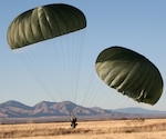 Soldiers from the 1st Platoon, 84th Engineer Support Company, 6th Engineer Battalion (Combat) (Airborne), conduct parachute landings during a training exercise at Fort Huachuca, Ariz., prior to beginning the construction of an access road for the Border Patrol. 
