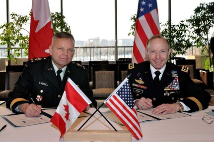 Canadian Forces Lieutenant-General Walter Semianiw, Canada Command commander (left) and Army Gen. Charles Jacoby, Jr., North American Aerospace Defense Command and U.S. Northern Command commander, sign military to military plans in Ottawa, Jan. 25, to enhance defense cooperation between Canada and the United States should the governments require each other's assistance. The documents signed were the Civil Assistance Plan, the Combined Defence Plan and an Information Sharing Memorandum of Understanding. Jacoby signed the CAP and the CDP in his capacity as the commander of USNORTHCOM and the MOU as the commander of NORAD and USNORTHCOM. The signings followed the 228th meeting of the Permanent Joint Board on Defence in Ottawa. 
