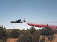A view from ground firefighting crews as MAFFS 6 drops fire retardant to aid in the control of the Donaldson fire. When full, the tanks being loaded hold 3,000 gallons of fire retardant. Established by Congress in the early '70s as a wildland fire protection program, MAFFS is a joint program with the Air National Guard, Air Force Reserve, and the U.S. Forest Service.
