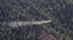 A UH-60 Black Hawk helicopter from the Colorado Army National Guard's 2nd Battalion, 135th General Support Aviation, drops 500 gallons of water from a specialized bucket onto the Lower North Fork Fire in the vicinity of Conifer Colo., March 28, 2012. Army National Guard Sgt. Ryan Osadchuk, a UH-60 Black Hawk helicopter crew chief with the Colorado Army National Guard's 2nd Battalion, 135th General Support Aviation Battalion, Company A, prepares his helicopter for flight at Buckley Air Force Base in Aurora, Colo., March 28, 2012. The 2-135th GSAB is operating under the governor's executive order to assist the Colorado Division of Emergency Management, the Colorado State Forest Service, and the Jefferson County Sheriff's Office in fighting the fire, which began March 26 in Jefferson County, Colo. The fire has given rise to the evacuation of more than 900 homes and is estimated to have covered more than 4,000 acres. 