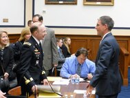 Gen. Charles H. Jacoby, Jr., North American Aerospace Defense Command and U.S. Northern Command commander, speaks to Representative Joe Heck (R-NV) before speaking to the House Armed Services Committee March 6, 2012. 
