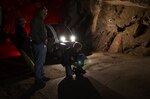 Partisan Pictures’ cameraman Ben McCoy collects film footage in limited lighting within the tunnel leading to the south portal inside Cheyenne Mountain Air Force Station while producer Jonathan Grupper and sound specialist Thomas Wilson (left background) look on. Partisan Pictures captured film footage at Cheyenne Mountain Air Force Station for a documentary project during the second week of April 2012. The project also included rare footage of a multi-threat NORAD and USNORTHCOM exercise in the Alternate Command Center. 
