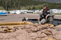 Colorado Army National Guard Staff Sgt. Everett Gray, 8th Civil Support Team, inflates a decontamination tent prior to 8th CST members conducting reconnaissance of a simulated contaminated area May 3, 2012, on the U.S. Air Force Academy. U.S. Army North, a subordinate of U.S. Northern Command, is responsible for evaluating CSTs every 18 months. 

