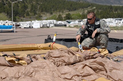 Colorado Army National Guard Staff Sgt. Everett Gray, 8th Civil Support Team, inflates a decontamination tent prior to 8th CST members conducting reconnaissance of a simulated contaminated area May 3, 2012, on the U.S. Air Force Academy. U.S. Army North, a subordinate of U.S. Northern Command, is responsible for evaluating CSTs every 18 months. 
