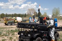Colorado Army National Guard Sgts. Steve Russ and Ryan Betz, 8th Civil Support Team, dismount from their vehicle and prepare to conduct reconnaissance of a simulated contaminated area May 3, 2012, during a Chemical, Biological, Radiological and Nuclear response exercise on the U.S. Air Force Academy. In this exercise scenario, a chemical sprayer (background) was used to make more than 200 Air Force Academy cadets ill, and the 8th CST was called out to provide support to local first responders. U.S. Army North, a subordinate of U.S. Northern Command, is responsible for evaluating CSTs every 18 months. 
