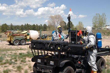 Colorado Army National Guard Sgts. Steve Russ and Ryan Betz, 8th Civil Support Team, dismount from their vehicle and prepare to conduct reconnaissance of a simulated contaminated area May 3, 2012, during a Chemical, Biological, Radiological and Nuclear response exercise on the U.S. Air Force Academy. In this exercise scenario, a chemical sprayer (background) was used to make more than 200 Air Force Academy cadets ill, and the 8th CST was called out to provide support to local first responders. U.S. Army North, a subordinate of U.S. Northern Command, is responsible for evaluating CSTs every 18 months. 
