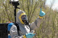 Colorado Army National Guard Sgt. Ryan Betz, 8th Civil Support Team, gives his partner, Sgt. Steve Russ, a thumbs-up to let him know he has not lost sight of him during a simulated reconnaissance mission as part of a Chemical, Biological, Radiological and Nuclear response exercise May 3, 2012. Two members of the 8th CST conducted the reconnaissance, always making sure to have visible contact with one another in case of an emergency. U.S. Army North, a subordinate of U.S. Northern Command, is responsible for evaluating CSTs every 18 months. 
