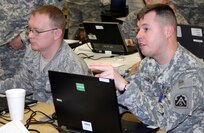 Staff Sgt. Joshua Cookson, common operating picture manager, Task Force 51, U.S. Army North, and Air Force Staff Sgt. Michael Davis, Illinois Air National Guard, work to establish procedures for a common operating picture during Exercise Silver Risk. The exercise focuses on the Dual-Status Command concept that will be used as the Department of Defense and Illinois National Guardsmen support the NATO Summit scheduled May 19-20 in Chicago. Led by the Illinois National Guard, it is the first time TF 51 Soldiers and civilians have participated under the authority of a dual-status command during a large scale command post exercise. Cookson said the COP being used was developed primarily at Army North, with some modifications being made by the Illinois Guard for its use. 
