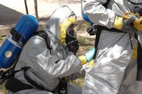 Colorado Army National Guard Sgt. Ryan Betz, 8th Civil Support Team, works quickly to repair a tear in Sgt. Steve Russ' chemical suit during a Chemical, Biological, Radiological and Nuclear response exercise on the U.S. Air Force Academy May 3, 2012. Russ's suit suffered a rupture during a simulated reconnaissance mission of a contaminated area, and Betz used tape to seal it before continuing with the mission. U.S. Army North, a subordinate of U.S. Northern Command, is responsible for evaluating CSTs every 18 months. 
