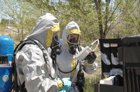 Colorado Army National Guard Sgts. Steve Russ and Ryan Betz check over their equipment before taking chemical samples from a sprayer during a Chemical, Biological, Radiological and Nuclear response exercise May 3 2012, at the U.S. Air Force Academy. The reconnaissance team will take samples of the chemical and bring it back to be examined in the 8th CST's mobile lab. U.S. Army North, a subordinate of U.S. Northern Command, is responsible for evaluating CSTs every 18 months. 
