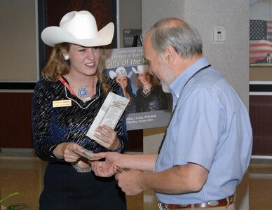 "Girl of the West" Amanda Summers greets members of NORAD and USNORTHCOM in the lobby of the commands' headquarters June 25. The Girls of West are promoting the Pikes Peak or Bust rodeo, which benefits military charities. 
