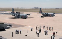 Two Modular Airborne Firefighting System-equipped C-130s from the 153rd Airlift Wing of the Wyoming Air National Guard park on the ramp at Peterson Air Force Base, Colo., June 25. The two aircraft will join two more MAFFS-equipped aircraft from the 302nd Airlift Wing assigned to Peterson Air Force Base in supporting wildland fire fighting efforts in Colorado. 
