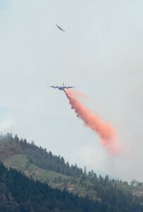 A U.S. Forest Service aircraft banks away after leading a Modular Airborne Firefighting System-equipped C-130 on a drop run over the Waldo Canyon fire near Colorado Springs, Colo., June 26, 2012. Four MAFFS-equipped aircraft, two from the 302nd Airlift Wing based at Peterson Air Force Base, Colo., and two from the 153rd Airlift Wing of the Wyoming Air National Guard, are supporting wildland fire fighting efforts in the state of Colorado. 
