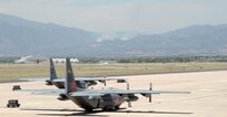 Two C-130s assigned to the 302nd Airlift Wing sit on the tarmac at Peterson Air Force Base, Colo. Four Modular Airborne Firefighting System-equipped C-130s from the 302nd and 153rd Airlift Wings have been assigned to support wildland fire fighting efforts in Colorado, dropping water and retardant on fires such as the Waldo Canyon fire burning in the background. 
