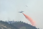 A U.S. Forest Service aircraft breaks away as a Modular Airborne Firefighting System-equipped C-130 begins dropping retardant on a section of the Waldo Canyon fire near Colorado Springs, Colo., June 26. Four MAFFS units from the 302nd and 153rd Airlift Wings are flying in support of the U.S. Forest Service as they fight wildland fires in Colorado. 
