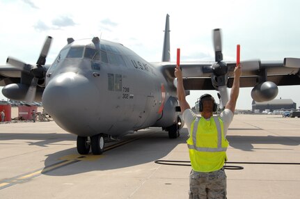 Airman Raymond DeSoto, 302nd Aircraft Maintenance Squadron, marshals a MAFFS-equipped C-130 at Peterson Air Force Base, Colo., June 29. MAFFS aircraft from the 302nd and 153rd Airlift Wings have been supporting Colorado wildland fire fighting efforts since June 25. 
