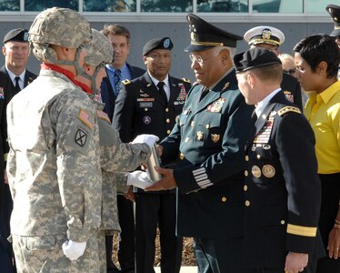 Members of the 3rd Battalion, 29th Field Artillery Regiment from Fort Carson, Colo., present Gen. Guillermo Galvan Galvan, Secretary of National Defense, Mexico, with an engraved artillery casing after honors were rendered to the general outside the Eberhart-Findley Building Oct. 19. The shell, along with a Mexican national flag flown in front of the NORAD and USNORTHCOM headquarters building, caps the end of Galvan’s last visit to the commands as Secretary of National Defense. His final two-day visit to Colorado Springs included a Modular Airborne Fire Fighting System demonstration by the 302nd Airlift Wing and visits with local community organizations. Galvan also took the opportunity to address a gathering of members of NORAD and USNORTHCOM where he discussed the vital relationship between the Mexican military and USNORTHCOM. Galvan is credited with enhancing the partnership between SEDENA and USNORTHCOM which is essential in the fight against transnational criminal organizations. This partnership in the counter-TCO mission is one of USNORTHCOM’s top priorities, and the command is committed to working together with the Mexican military against TCOs. Galvan steps down as Secretary of National Defense Dec. 1. 
