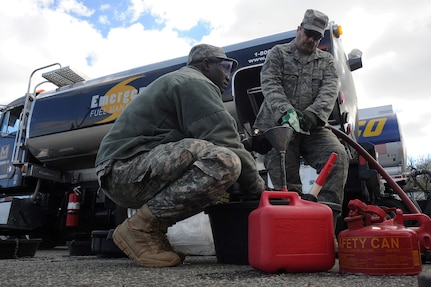 Army Sgt. Adama Ilbouda, left, with the New York Army National Guard, and Tech. Sgt. David Tayler, with the New York Air National Guard's 274th Air Support Operations Squadron, distribute fuel at the Staten Island Armory, Saturday, Nov. 3, 2012, to those affected by Hurricane Sandy. The fuel, available at no charge to those who need it, was provided by the Federal Emergency Management Agency and distributed at various armories throughout the New York and northern New Jersey areas.  (U.S. Army Photo by Sgt. 1st Class Jon Soucy)(Released)