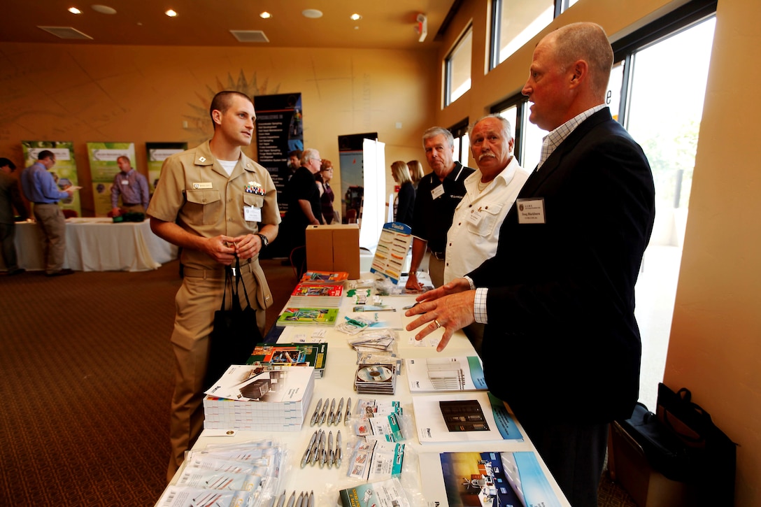 Navy Lt. Mike Duffy speaks with U.S. MILCOM Inc. during one of the networking sessions at the “Camp Pendleton Day” event held by the Society of American Military Engineers at the Pacific Views event center here July 18. Duffy is the Construction Manager for the Civil Engineer Corps at Camp Pendleton. The Society of American Military Engineers holds the annual “Camp Pendleton Day” event every year in support of the war fighter, specifically the engineering industry. 