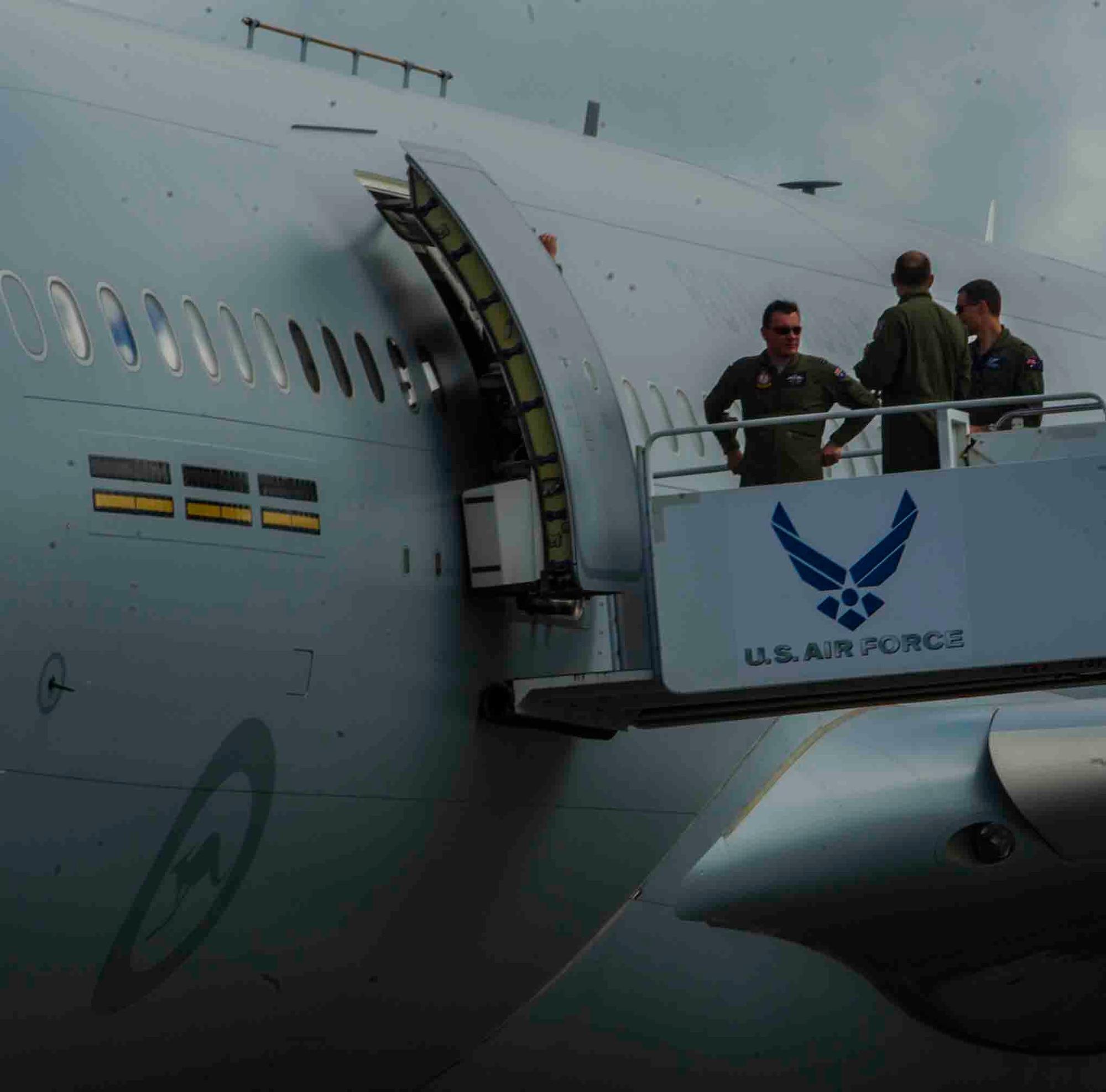 Members of the Royal Australian Air Force stand on the stairs of a "stair truck" after deplaning a KC-30 July 12, 2013, at Joint Base Pearl Harbor-Hickam, Hawaii, in support of Talisman Saber 2013. Talisman Saber is scheduled to take place from July 15 to August 5, 2013. Talisman Saber is a bilateral exercise designed to train Australian and U.S. forces in planning and conducting combined task force operations in order to improve combat readiness and interoperability. (U.S. Air Force photo by Staff Sgt. Nathan Allen)