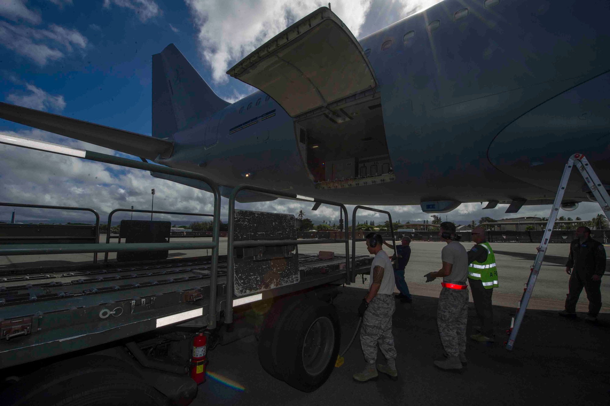 Members of the Royal Australian Air Force and U.S. Air Force Airmen work together to unload pallets from a KC-30 July 12, 2013, after the aircraft landed at Joint Base Pearl Harbor-Hickam, Hawaii, in support of Talisman Saber 2013. Talisman Saber forms part of the Australian Defense Force's extensive training program to ensure the ADF is prepared to protect and support Australia and its national interests. Talisman Saber is a bilateral exercise designed to train Australian and U.S. forces in planning and conducting combined task force operations in order to improve combat readiness and interoperability.  (U.S. Air Force photo by Staff Sgt. Nathan Allen)