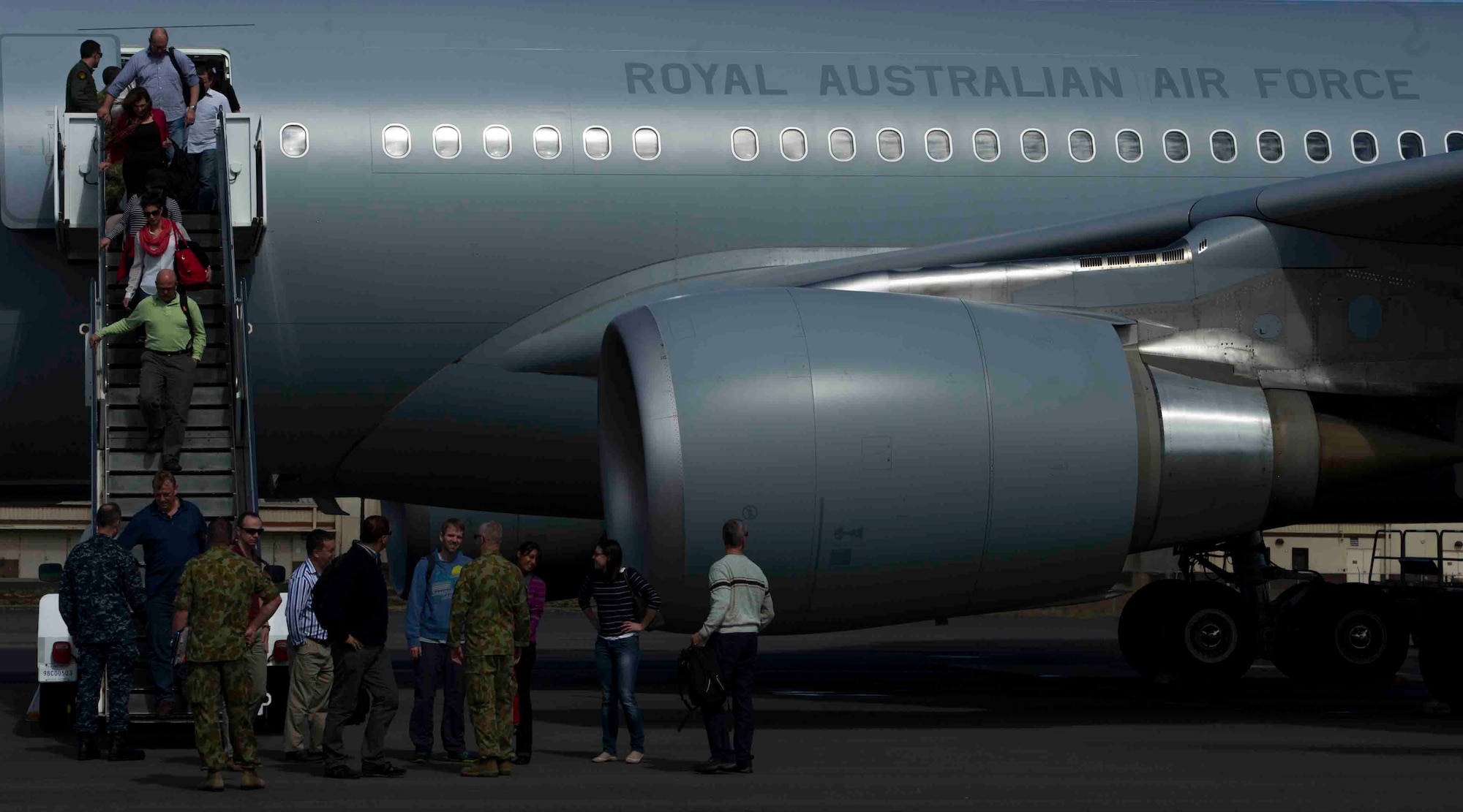 Australian civilians and members of the Royal Australian Air Force deplane a KC-30 July 12, 2013, at Joint Base Pearl Harbor-Hickam, Hawaii, after arriving to support Talisman Saber 2013. Talisman Saber is a bilateral exercise designed to train Australian and U.S. forces in planning and conducting combined task force operations in order to improve combat readiness and interoperability. (U.S. Air Force photo by Staff Sgt. Nathan Allen)