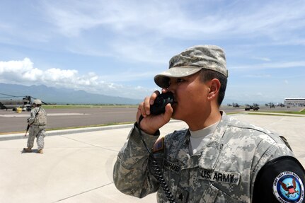 During a Honduran and American Anti-terrorism/Force protection exercise, here, U.S. Army Sgt. David Bouaphakeo, Joint Security Force’s Charlie flight chief, communicates with security forces members and augmentees as a local terrorist organization tried to gain access to the flight line July 17, 2013. JTF-Bravo conducts ATFP exercise to ensure personnel readiness, which ensures service members are ready for real world events at a moment’s notice. (Photo released by U.S. Air Force Staff Sgt. Jarrod Chavana)