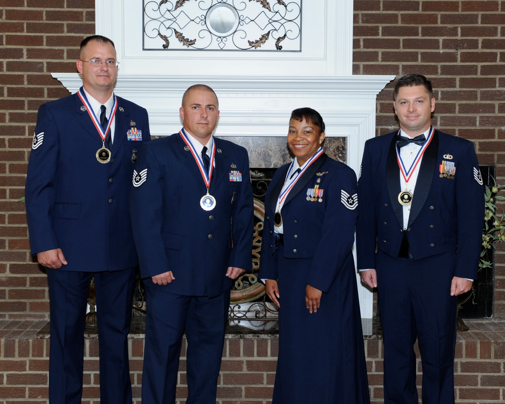 Master Sgt. James Pender, 14th Security Forces Squadron, Master Sgt. Damon Salter, 14th Security Forces Squadron, Master Sgt. Brenda Robinson, 14th Medical Operations Squadron, and Master Sgt. Jeremy Trout, 14th Operations Support Squadron, pose for a photo after receiving medals at the Senior Non-Commissioned Officer Induction ceremony July 11 at the Columbus Club. (U.S. Air Force Photo/ Elizabeth Owens)