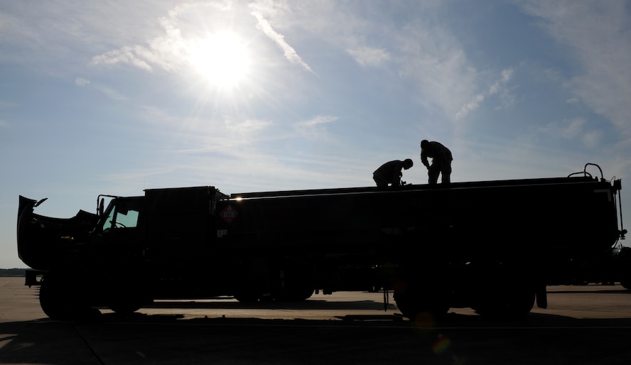 Fuel distributors from the 2nd Logistics Readiness Squadron check the fuel levels on a R-11 fuel truck on Barksdale Air Force Base, La., July 18, 2013. The R-11 fuel truck holds up to 6,000 gallons of JP-8 fuel. At its highest setting, the R-11 can pump 600 gallons of JP-8 per minute.(U.S. Air Force photo/Airman 1st Class Benjamin Gonsier)
