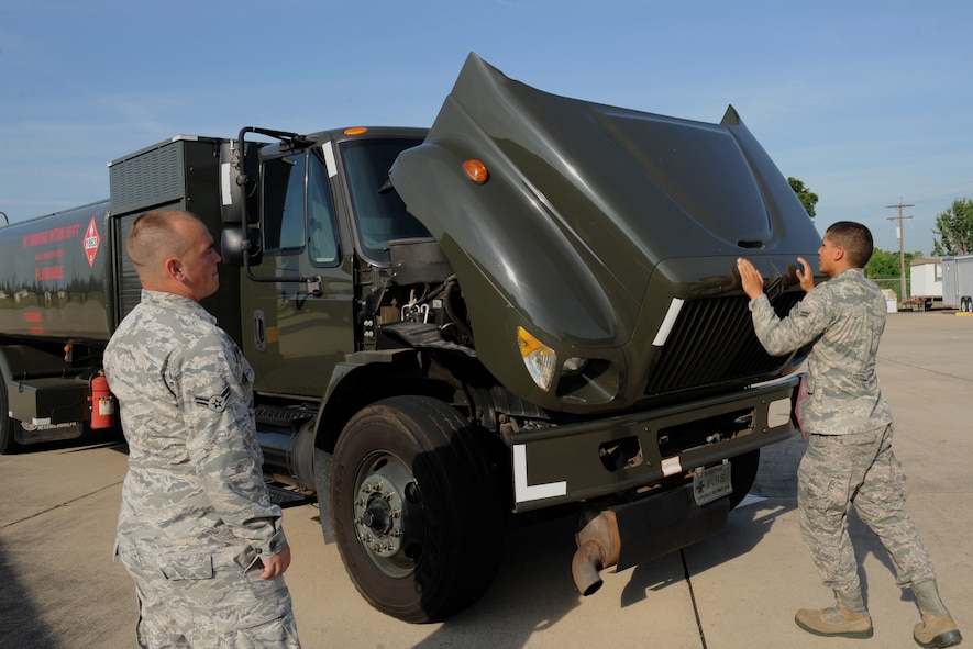Airman 1st Class Carlos Hernandez, right, 2nd Logistics Readiness Squadron fuels distribution, opens the hood to an R-11 fuel truck on Barksdale Air Force Base, La., July 18, 2013. Fuel trucks are maintained daily to ensure mission readiness and safety. (U.S. Air Force photo/Airman 1st Class Benjamin Gonsier)