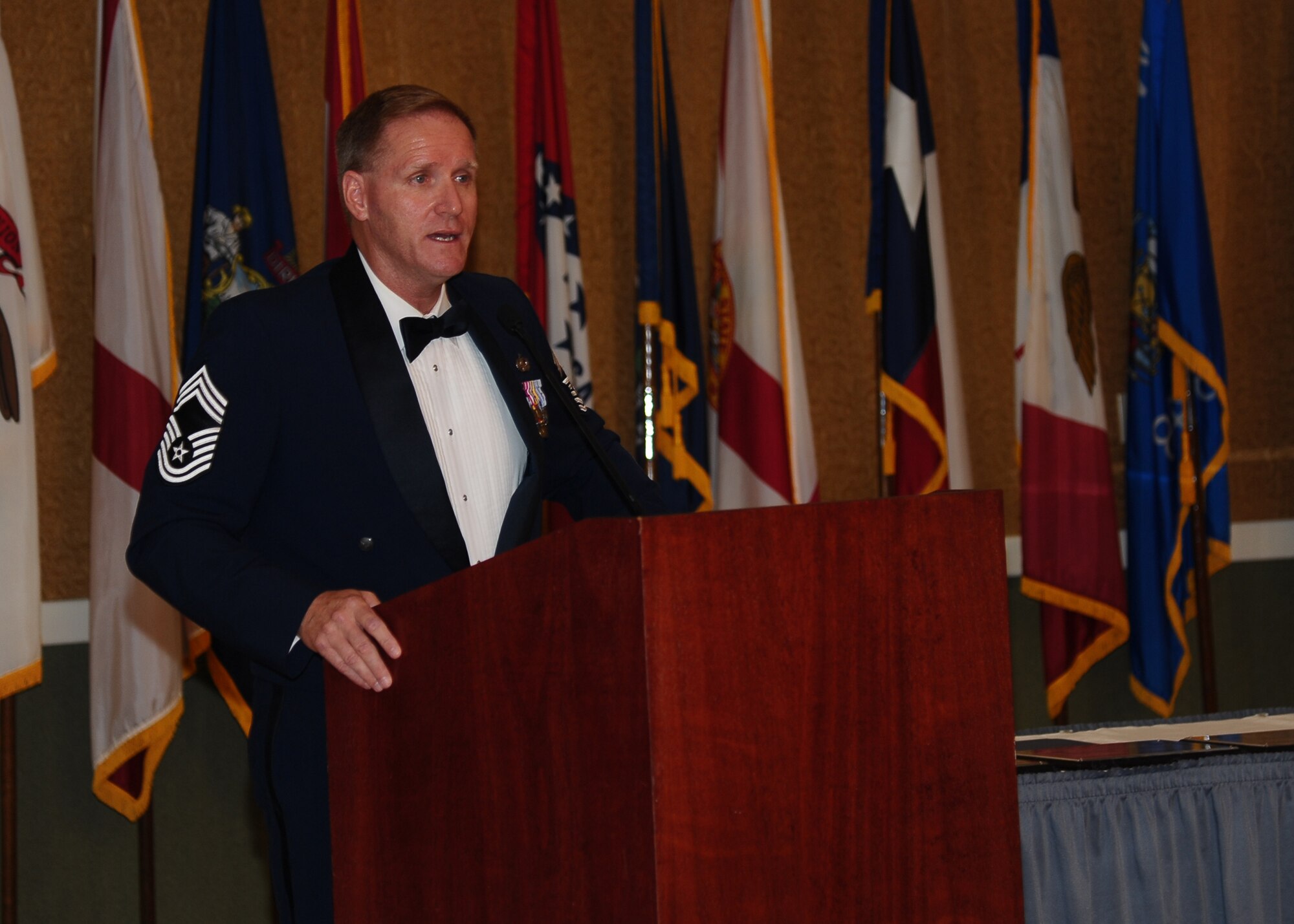 Chief Master Sgt. Carl Collins, Air National Guard Advisor to the Commander of Maxwell Air Force Base, addresses the audience during his speech at the Senior Non-Commissioned Officer Induction Ceremony July 11 at the Columbus Club. In his speech, he told the story of how personal fitness and a will to live saved an Airman suffering from a heart condition. (U.S. Air Force Photo/ Airman 1st Class Stephanie Englar)