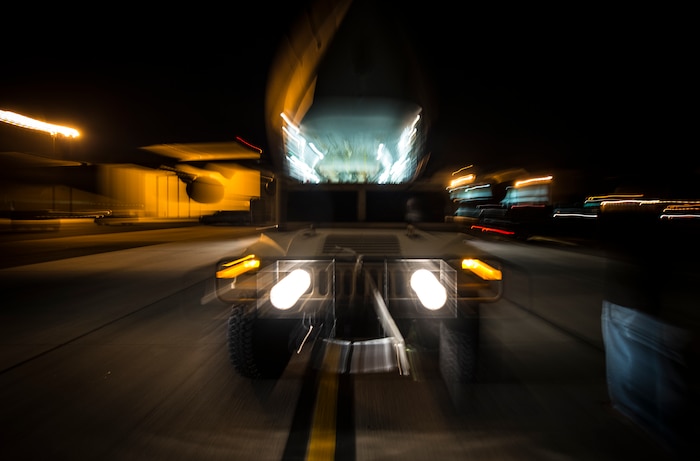 A Humvee is loaded onto a C-17 Globemaster III during an exercise to practice combat on-loading and off-loading July 17, 2013, at Joint Base Charleston – Air Base, S.C. Airmen from the 437th Airlift Wing work around the clock on the flightline to provide combat-ready C-17A aircrews, mission support personnel and processes for 53 assigned aircraft to meet White House, Department of State and Joint Chiefs of Staff-directed global deployment, employment and resupply of Department of Defense and allied forces via air-land and airdrop operations. (U.S. Air Force photo/ Senior Airman Dennis Sloan)