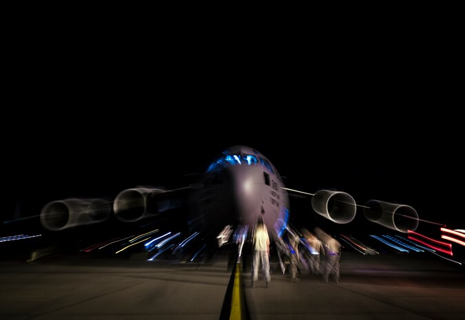 Aircrew members perform pre-flight checks on a C-17 Globemaster III before take-off to practice combat on-loading and off-loading July 17, 2013, at Joint Base Charleston – Air Base, S.C. Airmen from the 437th Airlift Wing work around the clock on the flightline to provide combat-ready C-17A aircrews, mission support personnel and processes for 53 assigned aircraft to meet White House, Department of State and Joint Chiefs of Staff-directed global deployment, employment and resupply of Department of Defense and allied forces via air-land and airdrop operations. (U.S. Air Force photo/ Senior Airman Dennis Sloan)