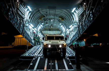 A Humvee is loaded onto a C-17 Globemaster III during an exercise to practice combat on-loading and off-loading July 17, 2013, at Joint Base Charleston – Air Base, S.C. Airmen from the 437th Airlift Wing  work around the clock on the flightline to provide combat-ready C-17A aircrews, mission support personnel and processes for 53 assigned aircraft to meet White House, Department of State and Joint Chiefs of Staff-directed global deployment, employment and resupply of Department of Defense and allied forces via air-land and airdrop operations. (U.S. Air Force photo/ Senior Airman Dennis Sloan)