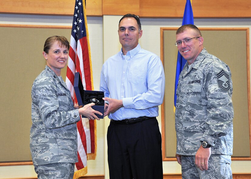 Kevin D. King, 341st Security Forces Squadron, center, was named Malmstrom AFB's Supervisor Category Two Civilian of the Quarter for the second quarter of 2013.  Shown presenting the award are Col. Marné Deranger, 341st Missile Wing vice commander, and Chief Master Sgt. Ronald Beadles, 341st Medical Group chief enlisted advisor.  The presentation was made at the Wing Quarterly Awards breakfast held July 16 at the Grizzly Bend.  (U.S. Air Force photo/ John Turner)