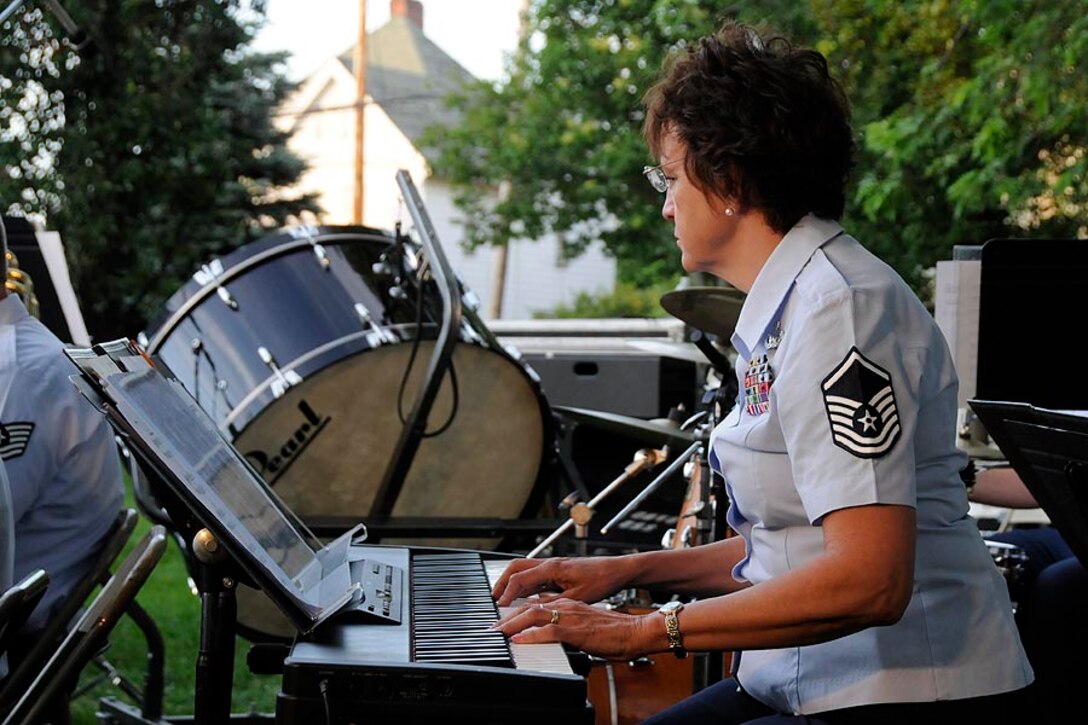 MSgt Dotty deTorres plays piano with the concert band.

Photo courtesy of TSgt Todd Pendleton, 182nd AW Public Affairs
