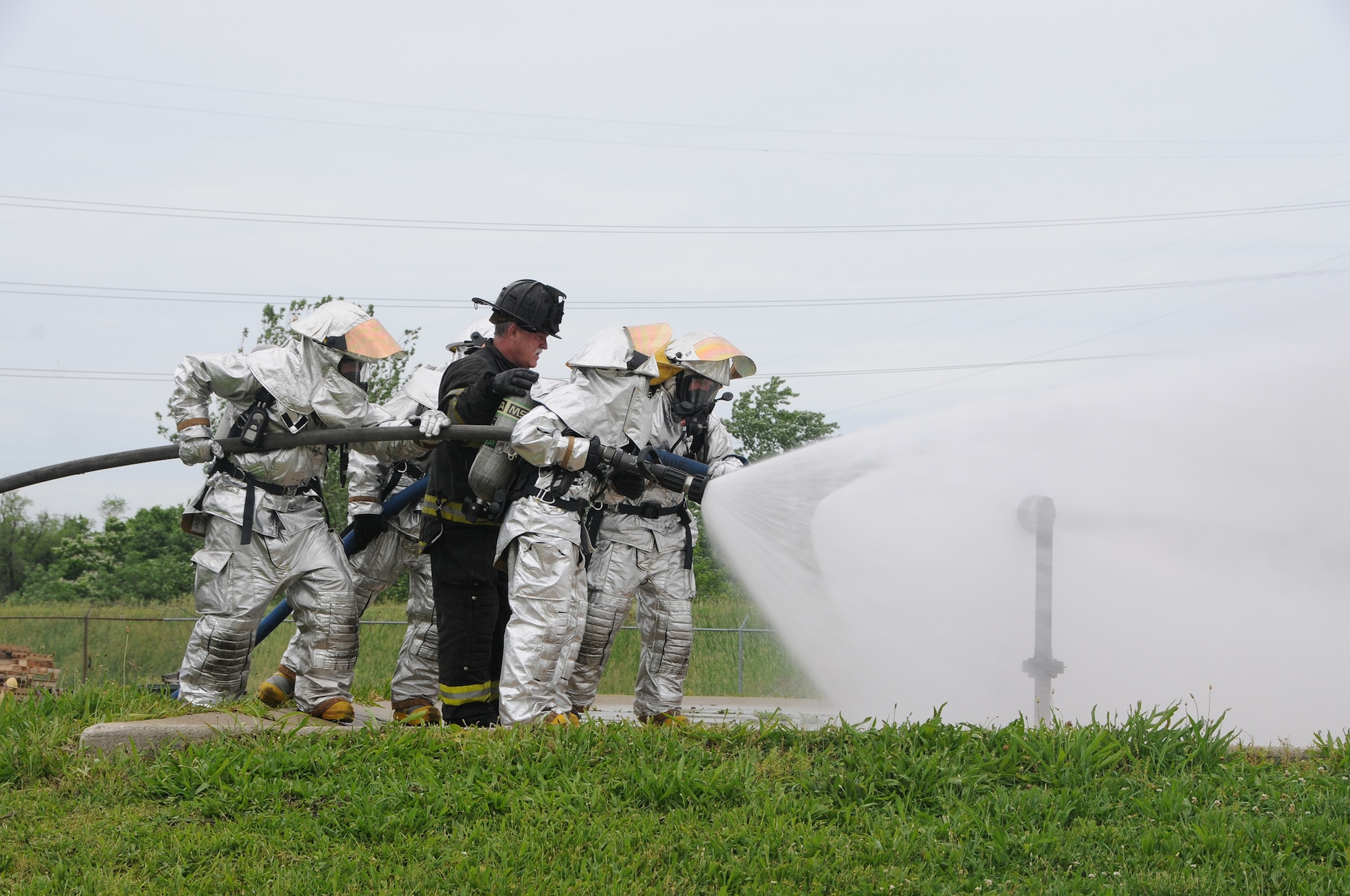 WRIGHT-PATTERSON AIR FORCE BASE, Ohio - Capt. Larry Ables, Dayton Fire Department, instructs firefighters from the 445th Civil Engineer Squadron Fire and Emergency Services Flight on technique as they douse a natural gas leak fire during a training session June 1 at the Dayton Fire Department Training Center. (U.S. Air Force photo/Tech. Sgt. Anthony Springer)