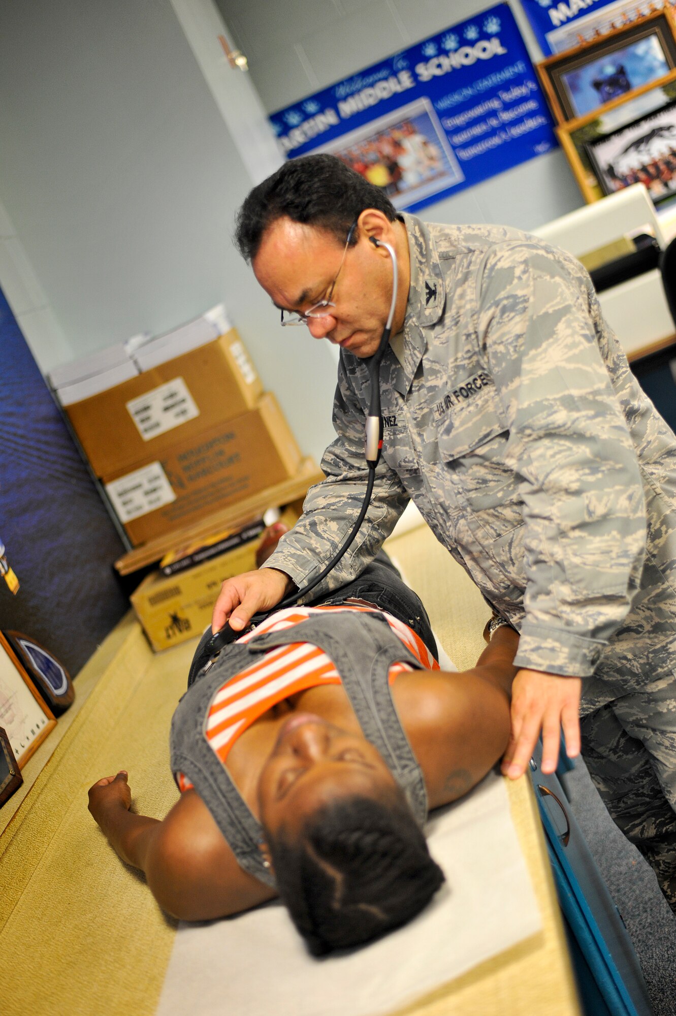 Col. Bo Marquinez, Medical Group Commander at the 180th Fighter Wing, Ohio Air National Guard, conducts a physical exam July 15, 2013, at Martin Middle School in Martin, Tenn. Marquinez and about 130 service members from the Air National Guard, Naval Reserves and the Army came together in the West Tenn. Community to provide free medical care as part of Innovative Readiness Training in support of the two-week “Hope of Martin” health fair. As of July 15, the medical team had provided medical care for over 2,000 members of the Martin and surrounding communities. Air National Guard photo by Master Sgt. Beth Holliker (Released). 